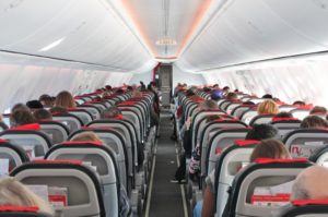 Airplane cabin aisle with rear view and seats