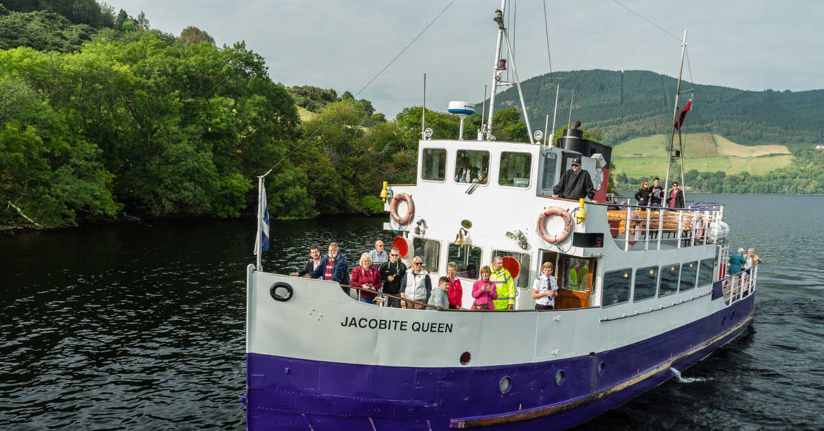 Loch Ness, Urquhart Castle, Scotland, UK - September 19, 2014: a Jacobite Cruises boat on approach to Urquhart Castle dock. Their ships carry tourists on sightseeing tours around Loch Ness shores.